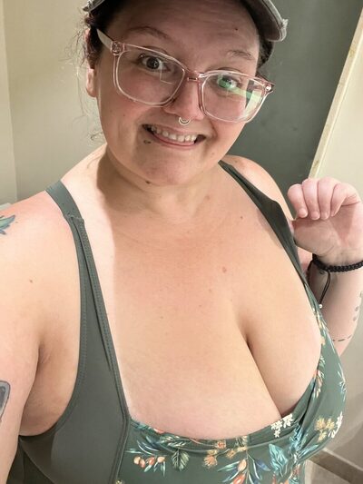 Sara Star — green floral swimsuit cap selfie